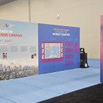 Large‑format event branding and exhibit walls installed at the Rotary International Convention, highlighting destination and program displays.