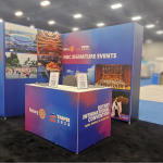 Large‑scale event installation featuring a custom hardwall booth at the Rotary International Convention inside the BMO Centre.